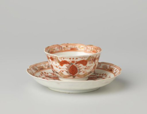 Bell-shaped cup and saucer with scrolls and stylised flowers