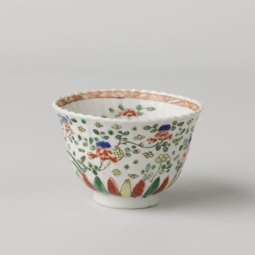 Cup with scattered flower sprays and border of standing petals