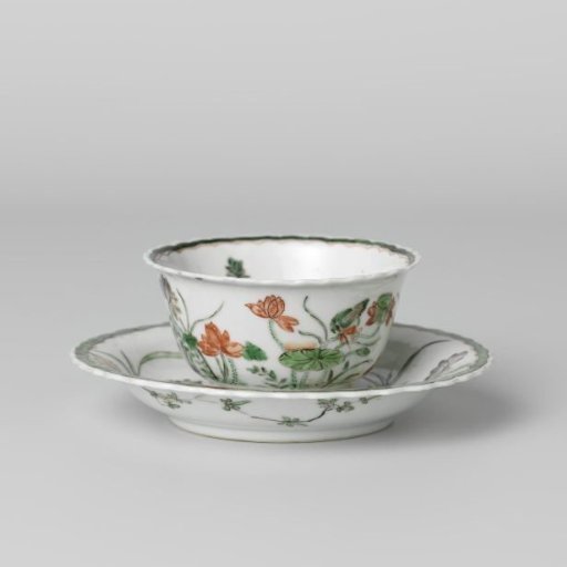 Cup and saucer with a pond, lotus plants, fish and birds