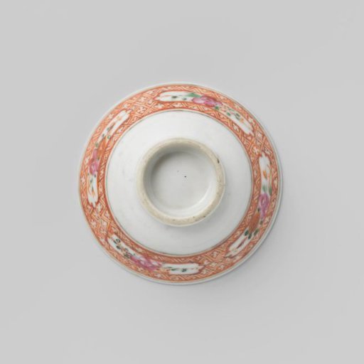 Bell-shaped cup and saucer with bouquets and floral scrolls on a diaper-pattern ground
