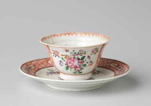 Bell-shaped cup and saucer with bouquets and floral scrolls on a diaper-patters ground