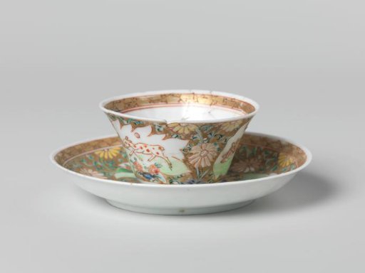 Cup and saucer with a cock and three deer in panels on a gold ground with floral scrolls