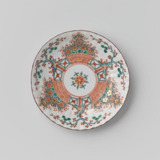 Saucer with fluted sides with a flower basket and a tree behind a fence