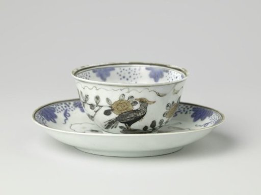 Bell-shaped cup and saucer with two pheasants on a rock in a leaf-shaped panel