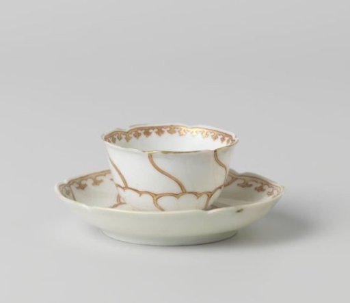 Cup and saucer with stylized flower and ornamental border
