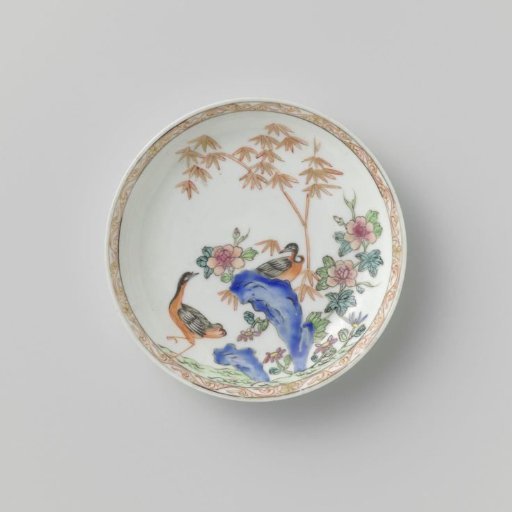 Saucer with two birds, rocks and flowering plants