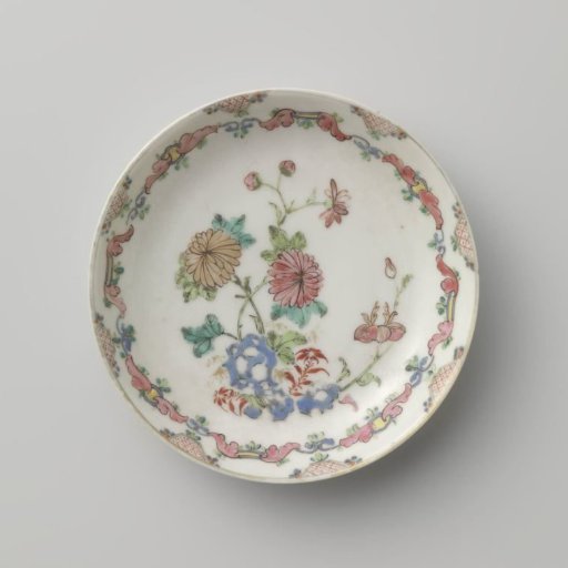 Saucer with flowering plants near a rock and scrolls