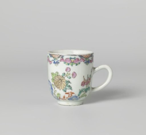 Chocolate cup with flowering plants near a rock and scrolls