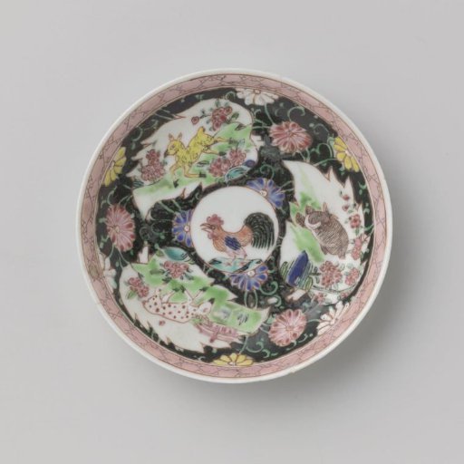 Saucer with cock and deer on a black ground with flower scrolls
