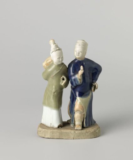 Figure of a walking man and woman with musical instruments