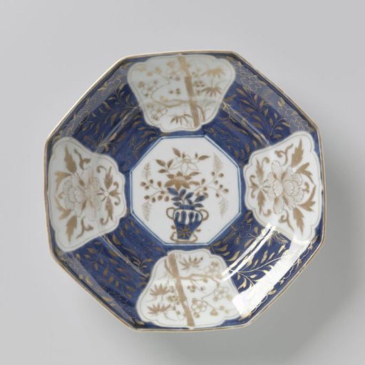Octagonal dish with flowering plants in panels and flower sprays