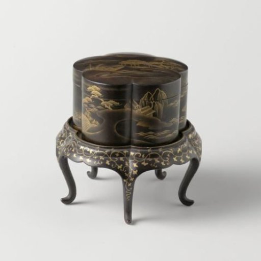 Box, lobed, on a separate foot, with gilded landscapes on a black ground