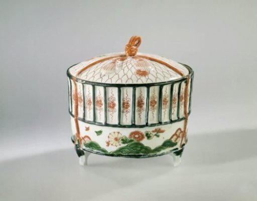 Cilidrical covered box in the shape of a cricket's cage