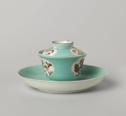 Bell-shaped covered cup and saucer with flowering plants in shaped panels