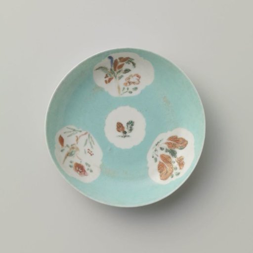 Saucer with flowering plants in shaped panels