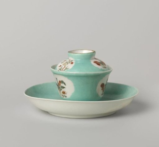 Bell-shaped covered cup and saucer with flowering plants in shaped panels