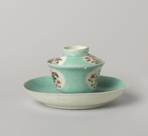 Bell-shaped covered cup and saucer with flowering plants in shaped panels