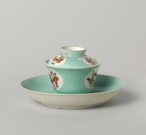 Rectangular tea caddy covered with a light blue glaze and antiquities in panels