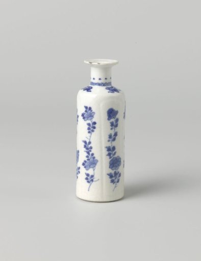 Small, cylindrical bottle vase with flower sprays and precious objects