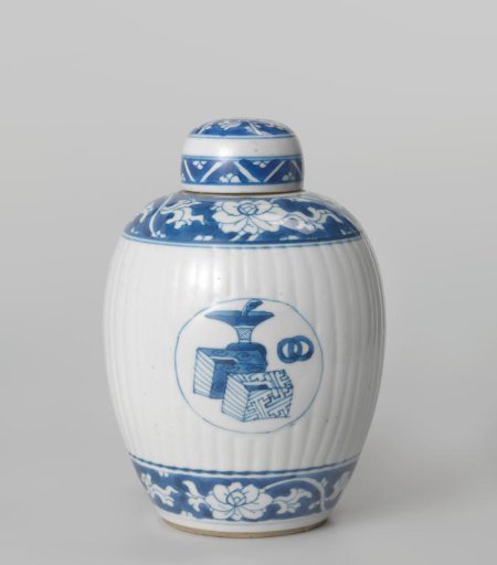Ovoid fluted covered jar with precious objects in medallions and floral scrolls