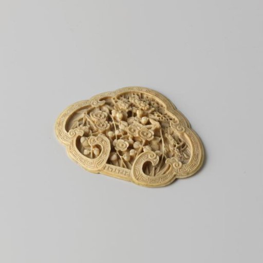 Ivory plate carved in the shape of a shell