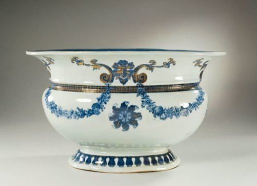 Oval basin with four masks connected by garlands