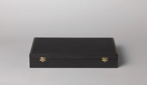 Box for fork and spoon of black leather with a golden rim on the lid. Two locks.