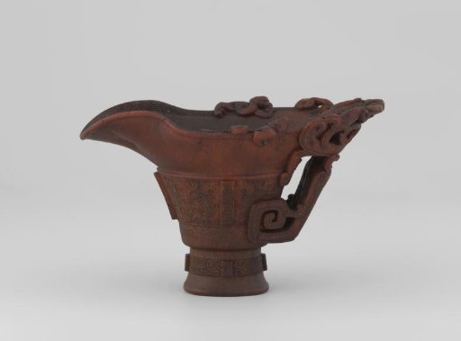 Carved rhino horn cup imitating bronze object with decorations of dragons