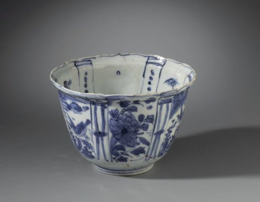 Bowl (crow cup) with flowering plants, flying birds and a bird on a rock