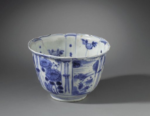 Bowl (crow cup) with flowering plants, flying birds and a bird on a rock