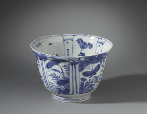 Bowl (crow cup) with flowering plants, flying birds and a bird on a rock