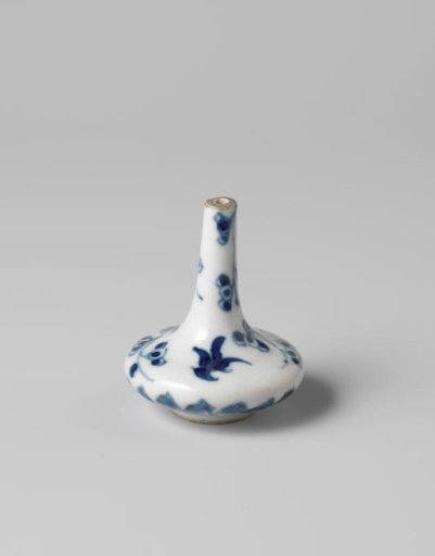 Miniature bottle vase with a prunus spray and bat