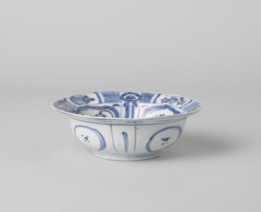 Klapmuts bowl with a bird on a rock near flowering plants