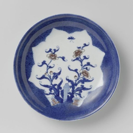 Saucer-dish with powder blue and shaped panel in reserve with flower sprays