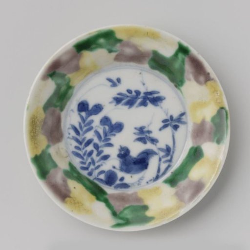 Saucer with 'egg and spinach' pattern and cock among plants