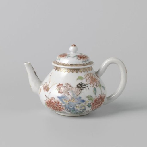 Teapot with a cock on a rock near flowering plants