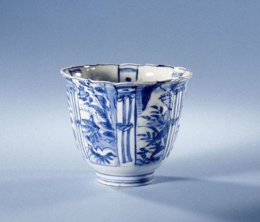 Bowl (crow cup) with flowering plants, insects and a bird on a rock