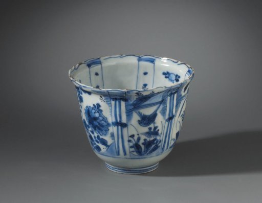 Bowl (crow cup) with flowering plants, flying birds and a bird on a rock