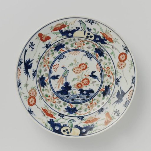 Plate with birds on rocks and near flowering plants