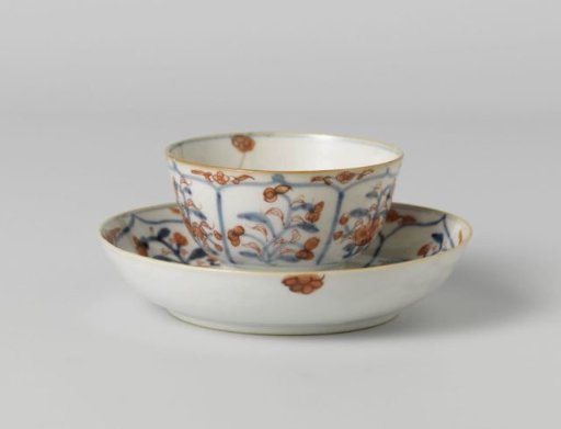 Cup and saucer with petal-shaped panel around a central medallion, filled with flower sprays