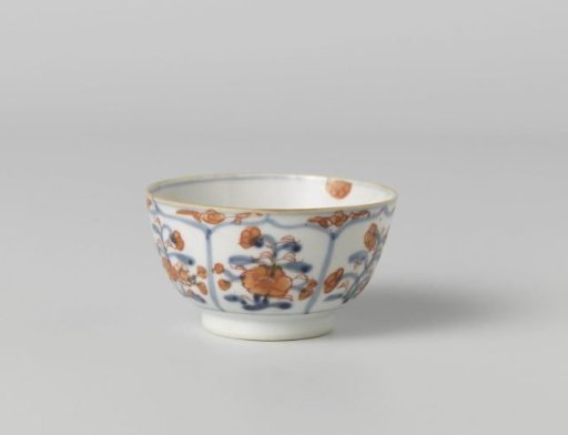 Cup with petal-shaped panel around a central medallion, filled with flower sprays