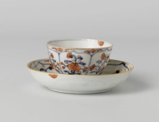 Cup and saucer with petal-shaped panel around a central medallion, filled with flower sprays