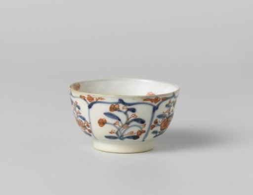 Cup with petal-shaped panel around a central medallion, filled with flower sprays