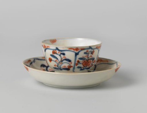 Cup and saucer with petal-shaped panel around a central medallion, filled with flower sprays