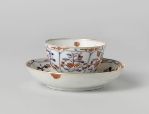 Cup and saucer with petal-shaped panel around a central medallion, filled with flower sprays