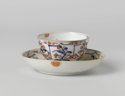 Cup and saucer with petal-shaped panel around a central medallion, filled with flower sprays