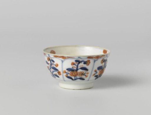 Cup with petal-shaped panel around a central medallion, filled with flower sprays