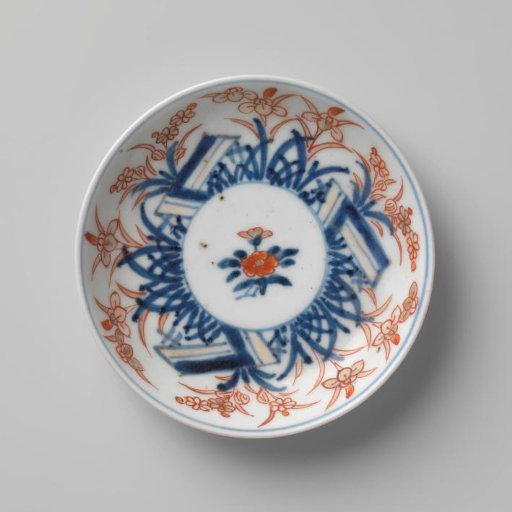 Saucer with a flower spray and flowering plants