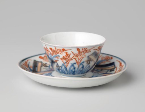 Bell-shaped cup and saucer with a flower spray and flowering plants
