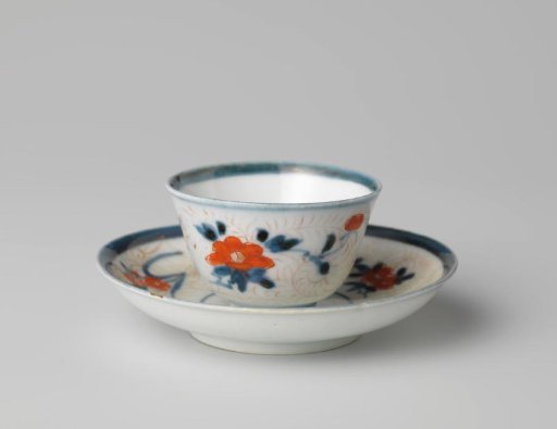 Bell-shaped cup and saucer with flower sprays and foliate scrolls
